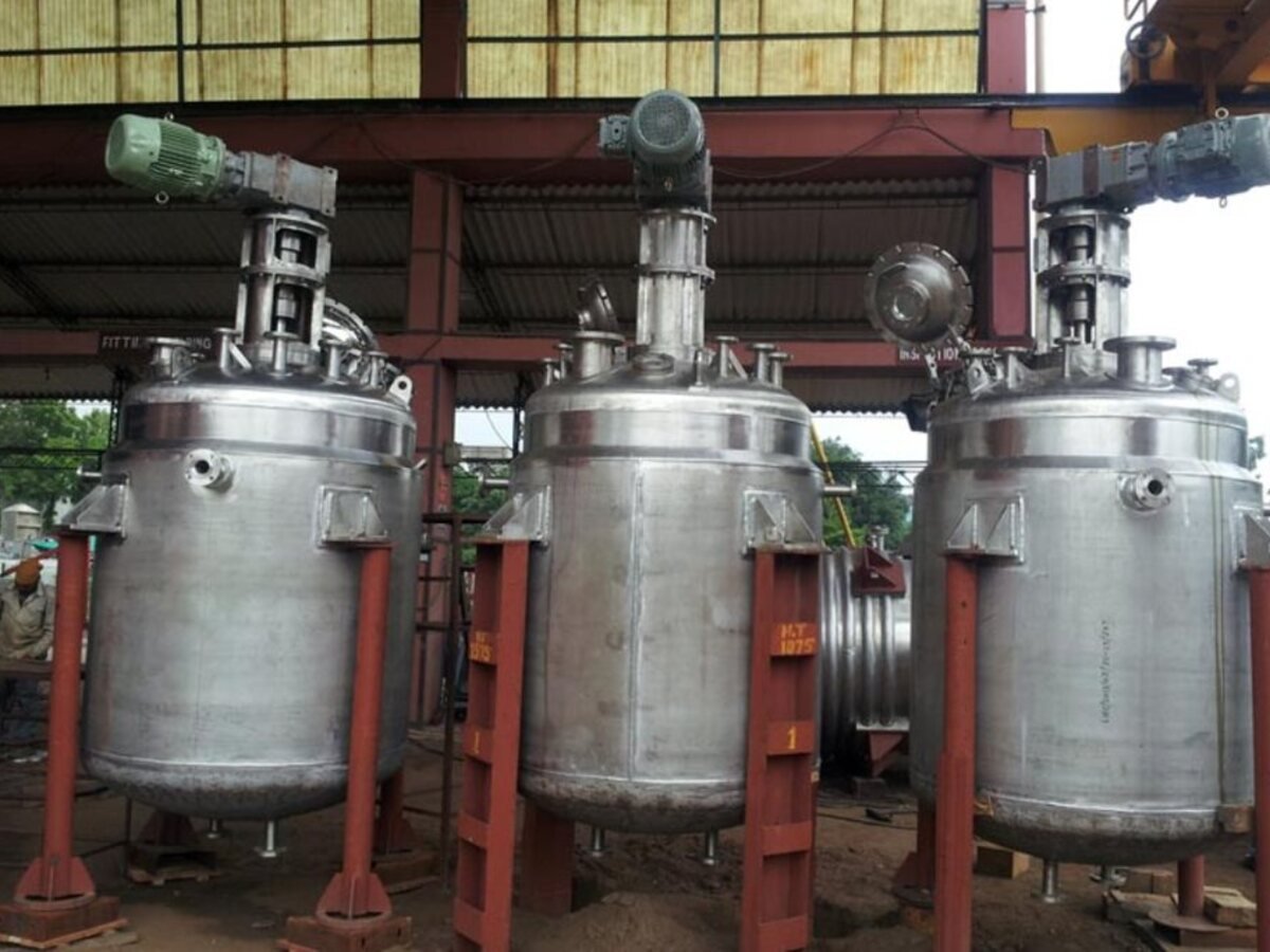 Bank of stainless steel reaction vessels with agitator drives